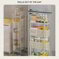 Two slim rolling carts in a kitchen gap beside the fridge, loaded with jars and bottles