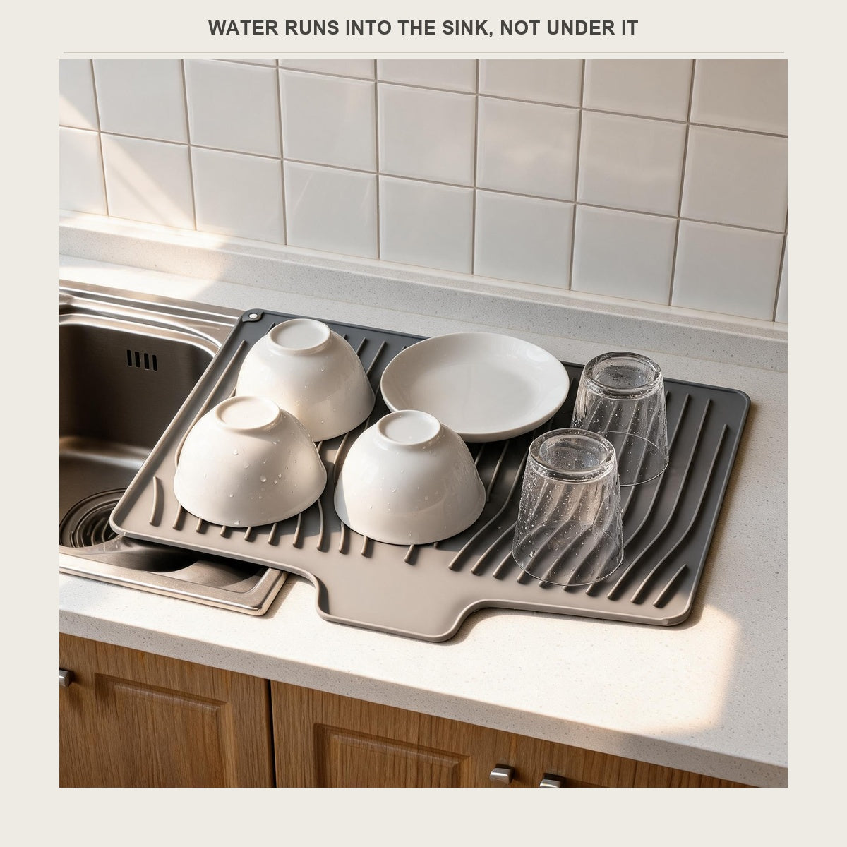 Silicone dish drying mat draining into a kitchen sink
